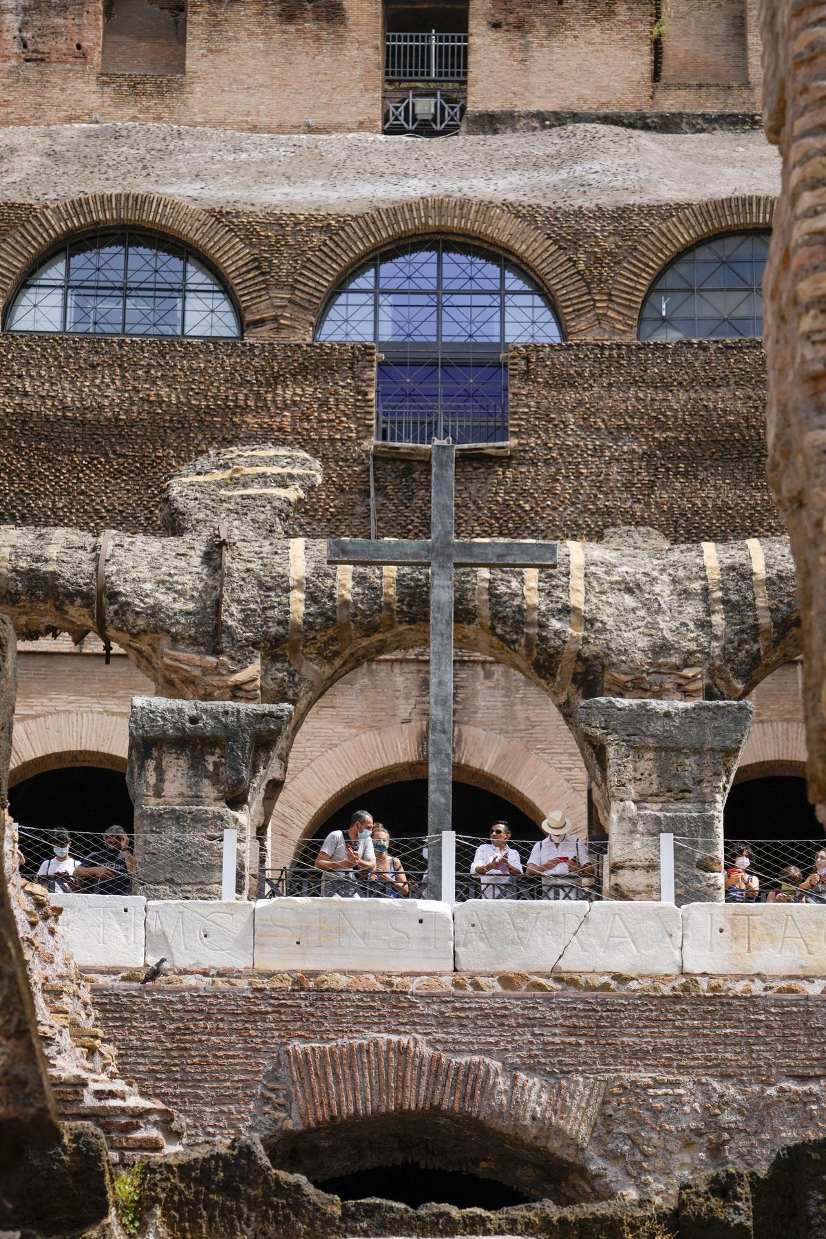 Visitors admire the newly restored lower level of the Colosseum during an event for the media, in Rome, Friday, June 25, 2021. After 2-and-1/2 years of work to shore up the Colosseum’s underground passages, tourists will be able to go down and wander through part of what what had been the ancient arena’s “backstage.”  (Andrew Medichini)