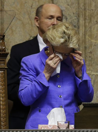 Gov. Chris Gregoire wipes her eyes after giving her final State of the State speech to a joint session of the Legislature Tuesday at the Capitol in Olympia. (Associated Press)