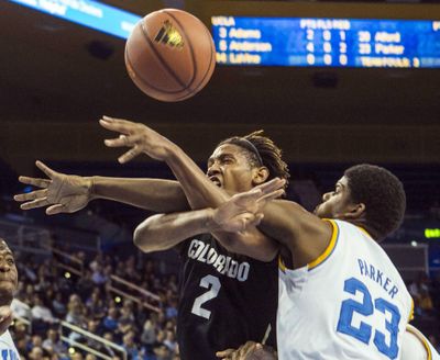 Colorado’s Xavier Johnson and UCLA’s Tony Parker battle for a loose ball in first half. (Associated Press)