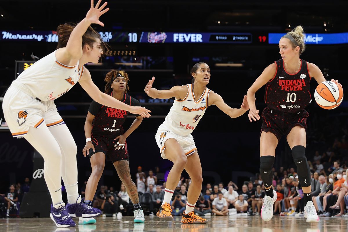 Lexie Hull of the Indiana Fever handles the ball against Phoenix’s Megan Gustafson, left, and Skylar Diggins-Smith during the first half Monday in Phoenix.  (Getty Images)