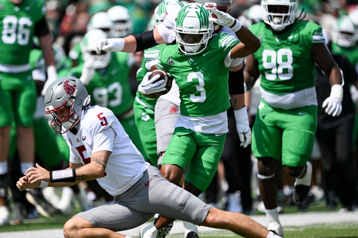 Washington State Cougars quarterback Jaxon Potter (5) dives in a failed attempt to stop North Texas Mean Green safety Evan Jackson (3) after Jackson intercepted Potter’s pass and returned it for 60 yards during the first half of a college football game on Saturday, Sep. 13, 2025 at DATCU Stadium in Denton, Texas. Potter threw three interceptions during the first half.  (Tyler Tjomsland/The Spokesman-Review)