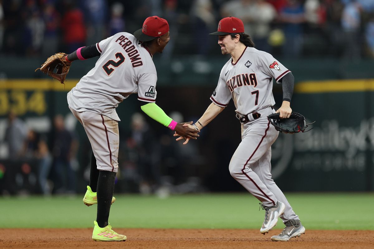 Arizona’s Geraldo Perdomo and Corbin Carroll celebrate Saturday after the Diamondbacks defeated the Texas Rangers 9-1 in Game Two of the World Series in Arlington, Texas.  (Getty Images)