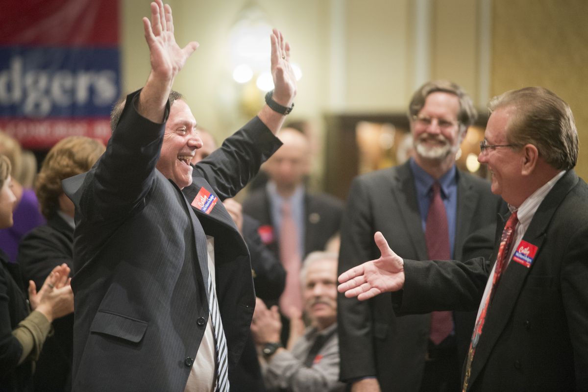 Larry Haskell, the presumed winner of the race for Spokane County prosecutor, celebrates after results are announced Tuesday at the Republican Party gathering at the Davenport Hotel. At right, hand extended, is Spokane County GOP Chairman Dave Moore. (Jesse Tinsley)