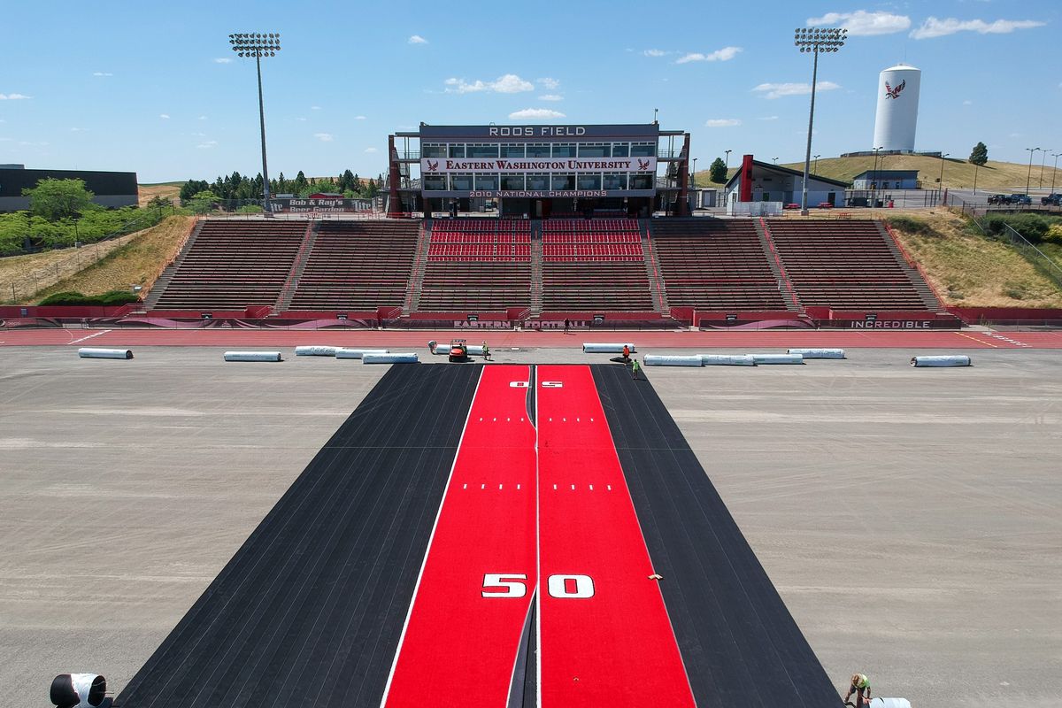 A crew from Coast to Coast Turf begins laying down the new red Astroturf surface on Roos Field at Eastern Washington University, Tuesday, July 21, 2020.  (Jesse Tinsley/The Spokesman-Review)