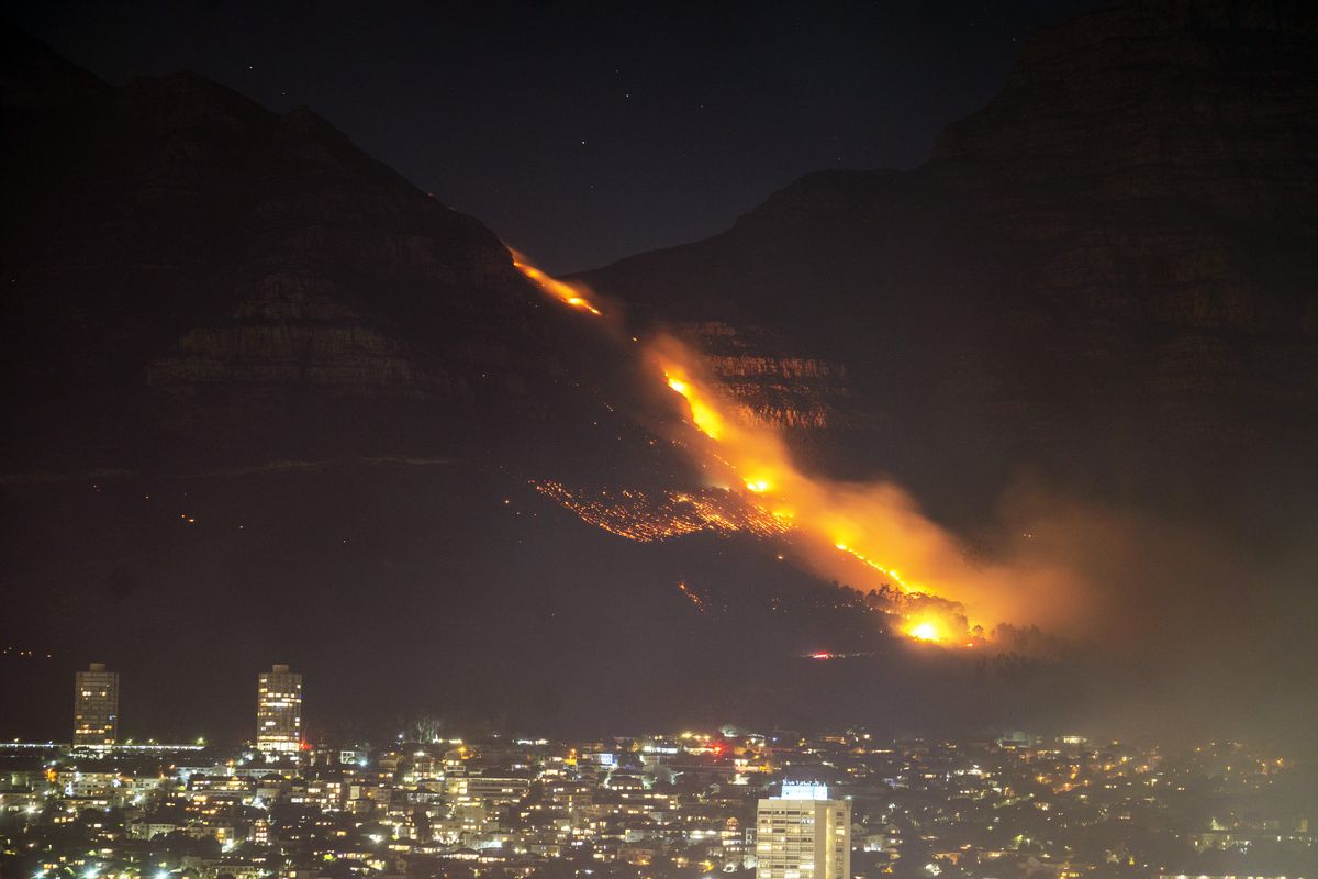 Residential neighborhoods are lit by raging fires Monday in Cape Town, South Africa.  (Jerome Delay)