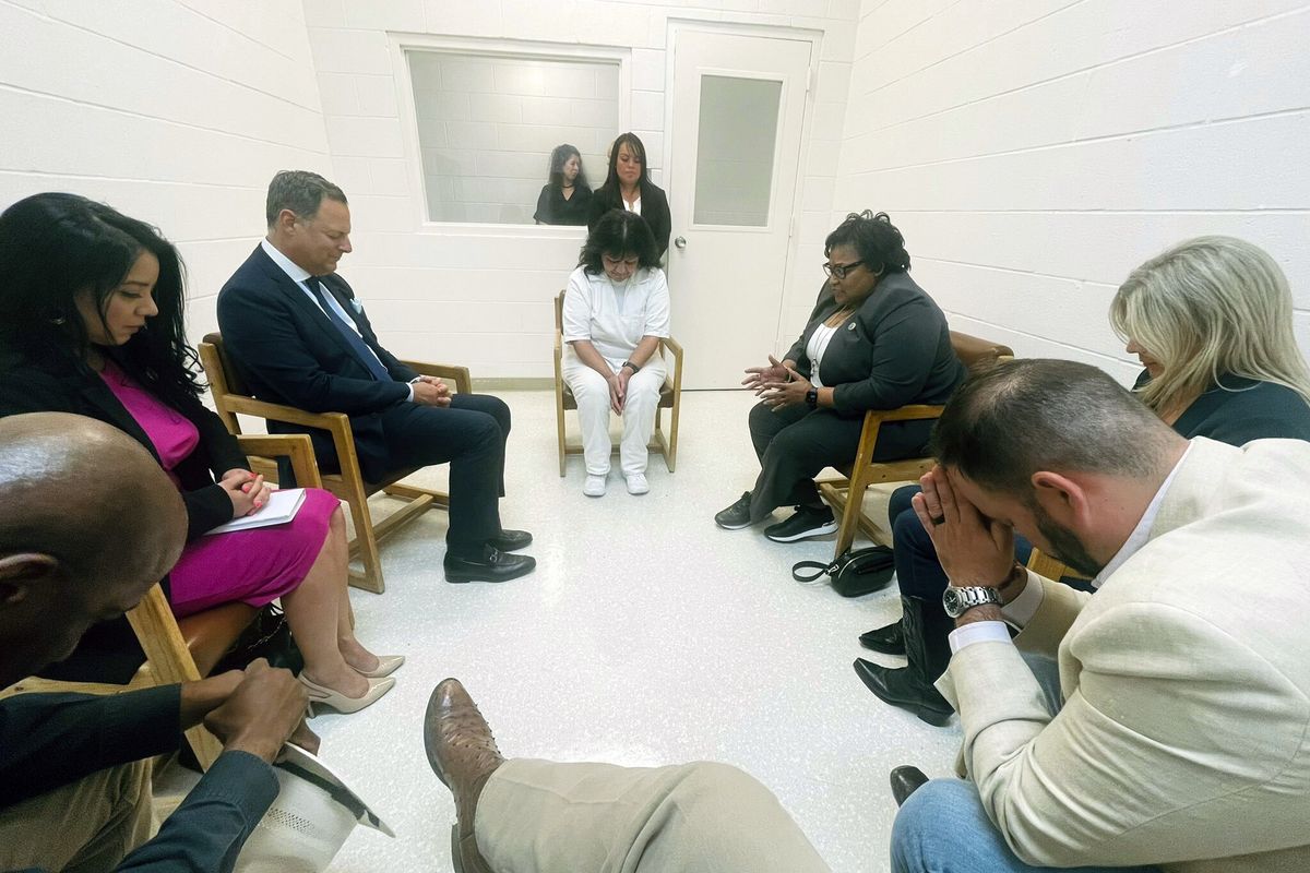 In this April 6, 2022 photo provided by Texas state Rep. Jeff Leach, Texas death row inmate Melissa Lucio, dressed in white, leads a group of seven Texas lawmakers in prayer in a room at the Mountain View Unit in Gatesville, Texas. The lawmakers visited Lucio to update her about their efforts to stop her April 27 execution. The lawmakers say they are troubled by Lucio’s case and believe her execution should be stopped as there are legitimate questions about whether she is guilty.  (HOGP)