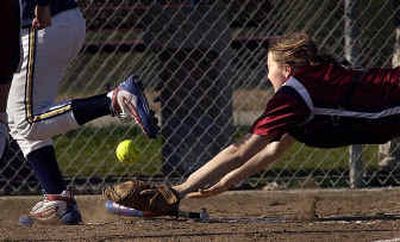 
Mt. Spokane catcher Jackie Purser comes up short for a foul ball off a bunt down the first baseline in the 5th inning against Mead Tuesday afternoon. 
 (Brian Plonka / The Spokesman-Review)