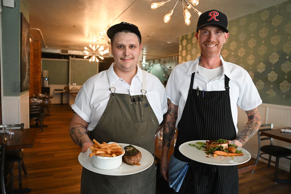 Owner Todd Andrews, right, and chef de cuisine Shaun Ratty stand with some of their signature dishes at their new French restaurant, Bowery, at 230 W. Riverside Ave.  (Jesse Tinsley/The Spokesman-Review)