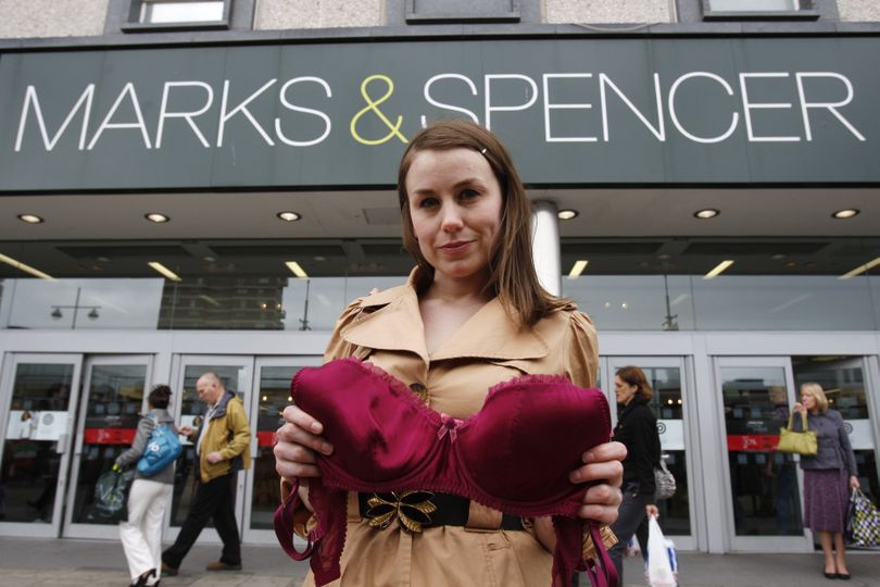 ORG XMIT: LST113 Beckie Williams, co-founder of Busts 4 Justice, poses with a bra outside a branch of Marks & Spencer in Brighton, England, Thursday, May 7, 2009. The women group campaigning to challenge Marks & Spencer's policy of charging more for large-sized brassieres, a 2 pound (US$3) surcharge for bra sizes that are DD or larger, say they plan to confront executives at the group's annual meeting this summer. (AP Photo/Sang Tan) (Sang Tan / The Spokesman-Review)