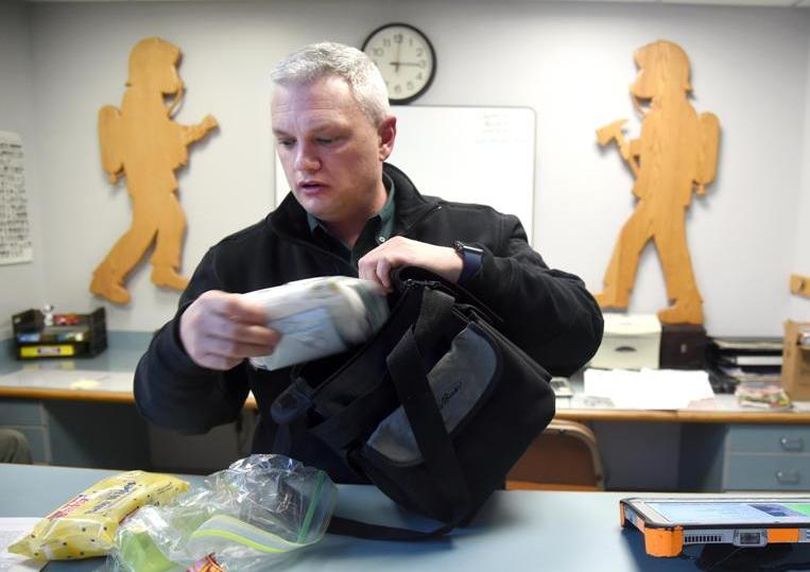 Spokane Assistant Fire Chief Brian Schaeffer shows the small satchel of baby essentials kept at the front desk of area of a Spokane Fire station Monday, Feb. 1, 2016. A newborn baby was dropped at Station 8 on Monday and was transferred to the hospital for more observation. (Jesse Tinsley)