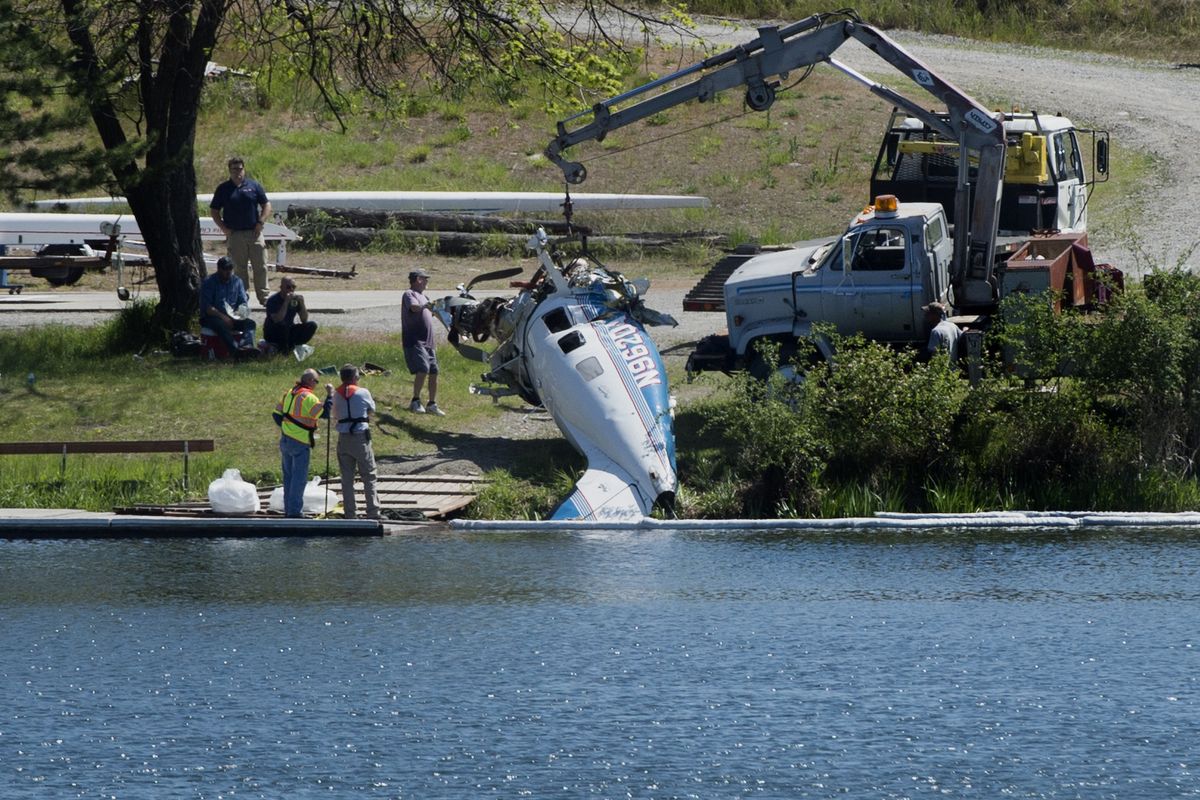 The wreckage of a 1996 Piper Malibu flown by Lyndon Amestoy and Richard Runyon is pulled from the Spokane River on Saturday near Felts Field in Spokane. (Tyler Tjomsland)