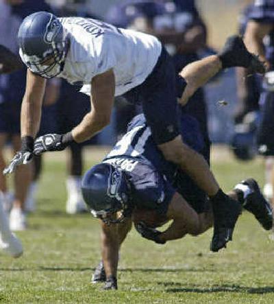 
Seattle linebacker Niko Koutouvides trips over Jerome Pathon at practice. 
 (Associated Press / The Spokesman-Review)