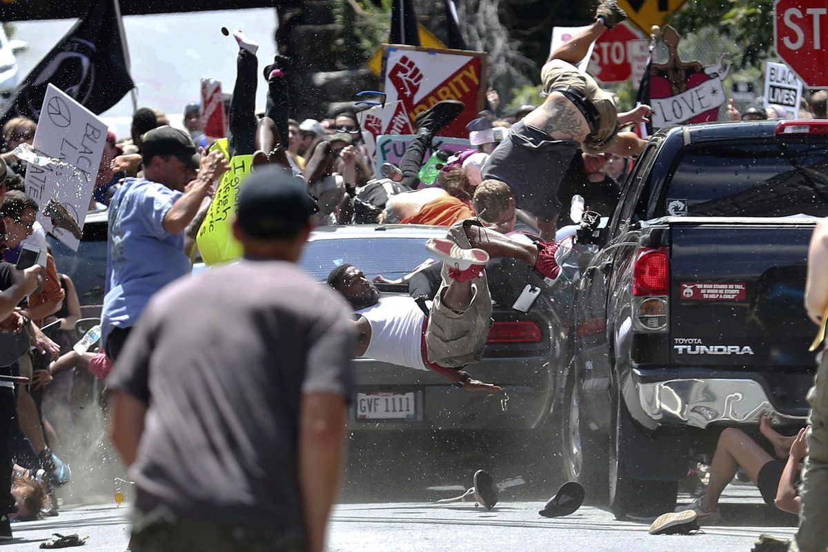 People fly into the air as a vehicle is driven into a group of protesters demonstrating against a white nationalist rally in Charlottesville, Va., on Aug. 12, 2017. James Alex Fields Jr., the man accused of driving into the crowd demonstrating against a white nationalist protest, killing one person and injuring many more, had a preliminary court hearing Thursday, Dec. 14, 2017. (Ryan M. Kelly / Associated Press)