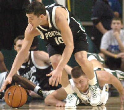 
Portland State's Josh Neely, center, picks up a loose ball in a win against Oregon Tuesday.
 (Associated Press / The Spokesman-Review)