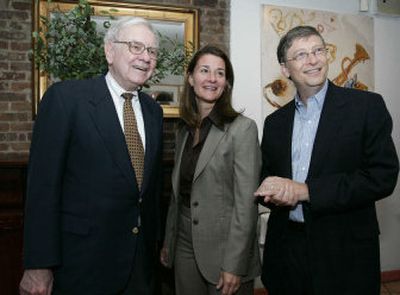 
Melinda and Bill Gates greeted Warren Buffett on Sunday in New York. 
 (Associated Press / The Spokesman-Review)