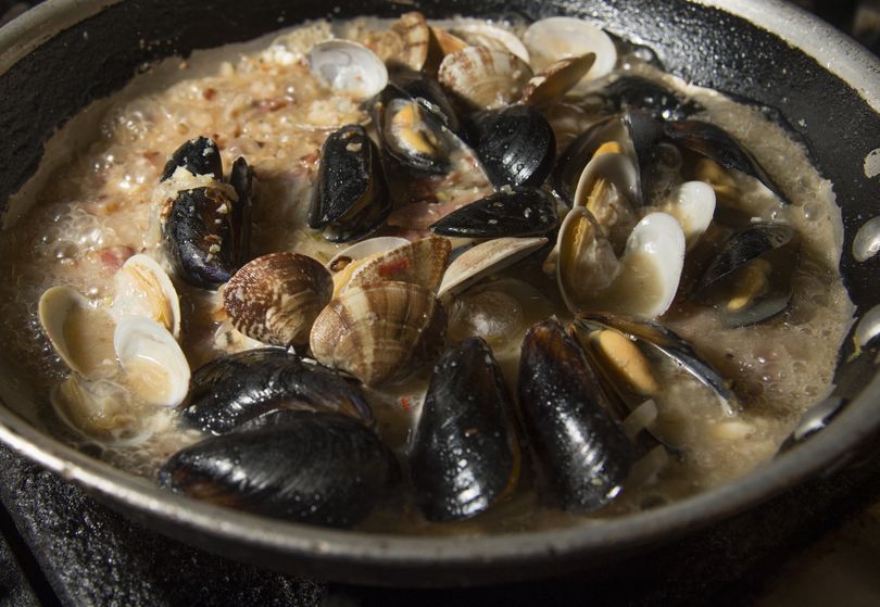 Stacks at Steam Plant offers Steamed Shellfish – Penn Cove mussels and Manila clams sautéed with smoked bacon, garlic, shallots and basil and steamed in Cutter’s Pale Ale. They are served with a side of grilled garlic bread and lemon wedges. (Colin Mulvany)