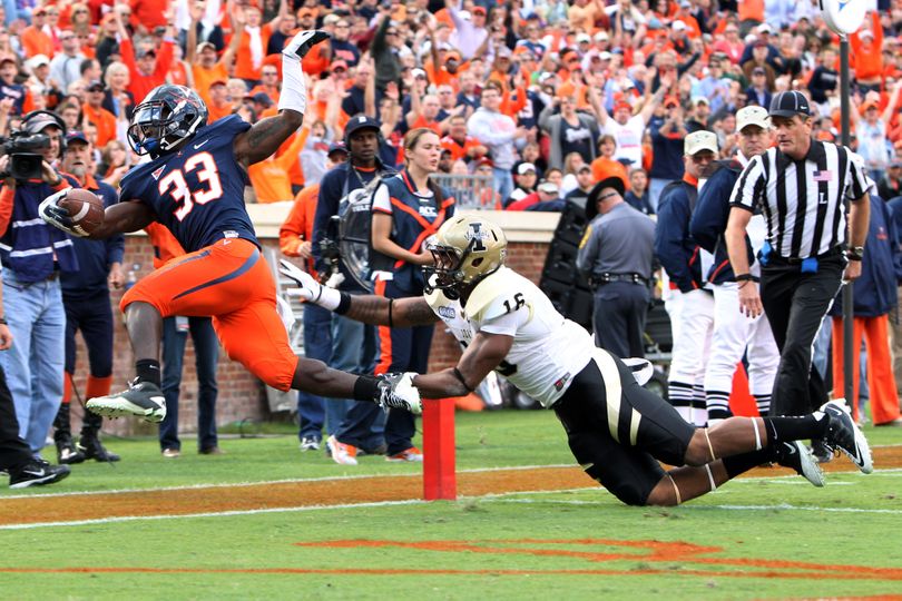 Virginia running back Perry Jones (33) leaps into the end zone with Idaho linebacker Korey Toomer, right, on his tail to score a touchdown during the first half of their NCAA college football game at Scott Stadium, Saturday, Oct. 1, 2011, in Charlottesville, Va. (Sabrina Schaeffer / The Daily Progress)