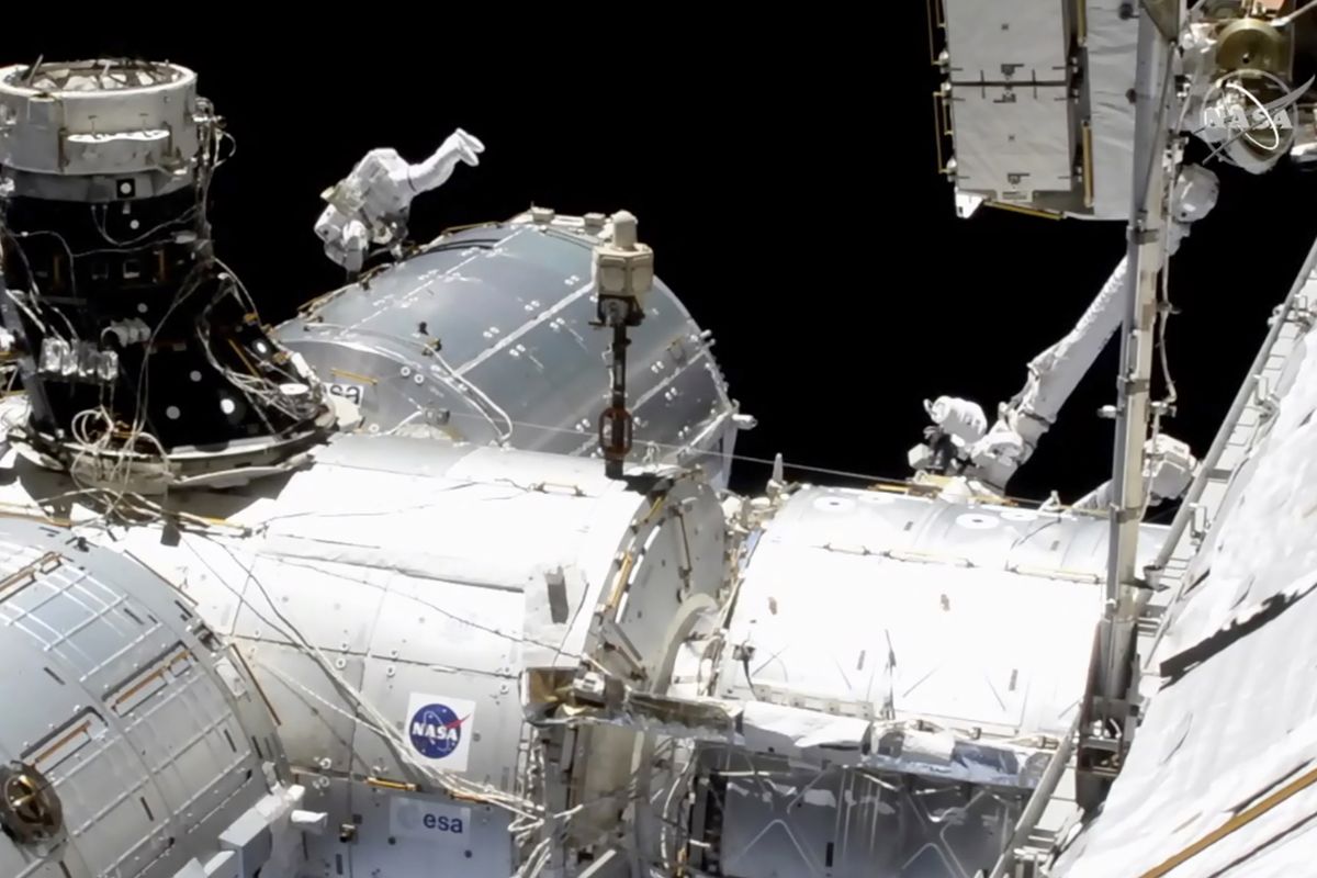 In this image taken from NASA video, NASA astronaut Mike Hopkins works outside the International Space Station’s European lab on Wednesday, Jan. 27, 2021. Hopkins and Victor Glover went spacewalking Wednesday to install a high-speed data link outside the International Space Station’s European lab and connect cables for an experiment platform awaiting activation for almost a year.  (HOGP)