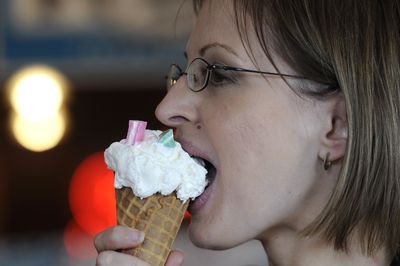 Spokandy manager Natalie Vlasaty tastes a mint ice cream and Spokandy Mints cone at the store in Spokane. (Dan Pelle / The Spokesman-Review)