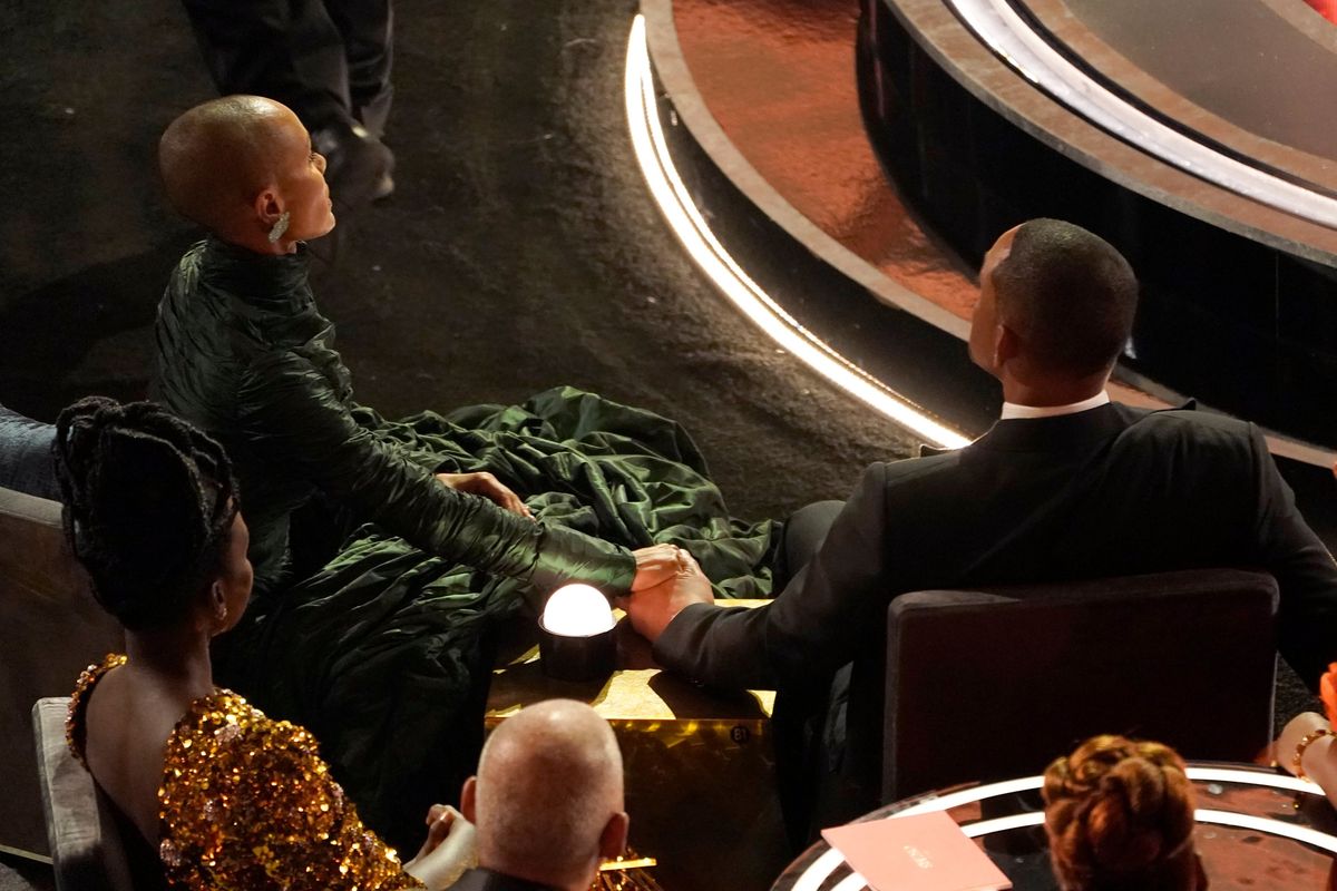 FILE - Jada Pinkett Smith, left, and Will Smith hold hands in the audience at the Oscars on March 27, 2022, at the Dolby Theatre in Los Angeles. The stunning physical altercation between actor Will Smith and comedian Chris Rock at the 94th Academy Awards on Sunday has sparked debate about the appropriate ways for Black men to publicly defend Black women against humiliation and abuse. (Chris Pizzello)
