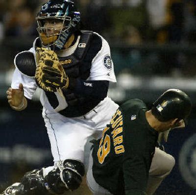 
 Oakland's Marco Scutaro slides safely into home in front of catcher Rene Rivera. 
 (Associated Press / The Spokesman-Review)
