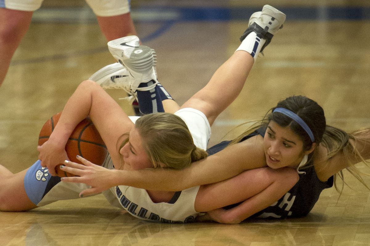 Gonzaga Prep’s Laura Stockton, left, and Chiawana’s Darbi Pink scramble for a loose ball during the first half. (Colin Mulvany)