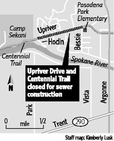 
Daryl Lohstroh rides his bicycle through the construction zone on Upriver Drive to get to his nearby residence Thursday. Upriver Drive will be closed until July 9 for a sewer project, and motorists should use alternate routes to bypass the construction. 
 (Holly Pickett / The Spokesman-Review)