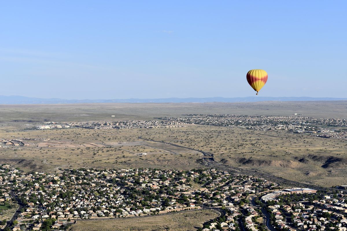 This July 2017 photo shows a Rainbow Ryders hot air balloon in flight over the Rio Grande Valley surrounding Albuquerque, New Mexico. Hot air balloon rides are one of the main outdoor activities tourists enjoy in New Mexico due to optimal climate conditions in the state. (AP Photo/Amir Bibawy) ORG XMIT: NYLS211 (Amir Bibawy / AP)