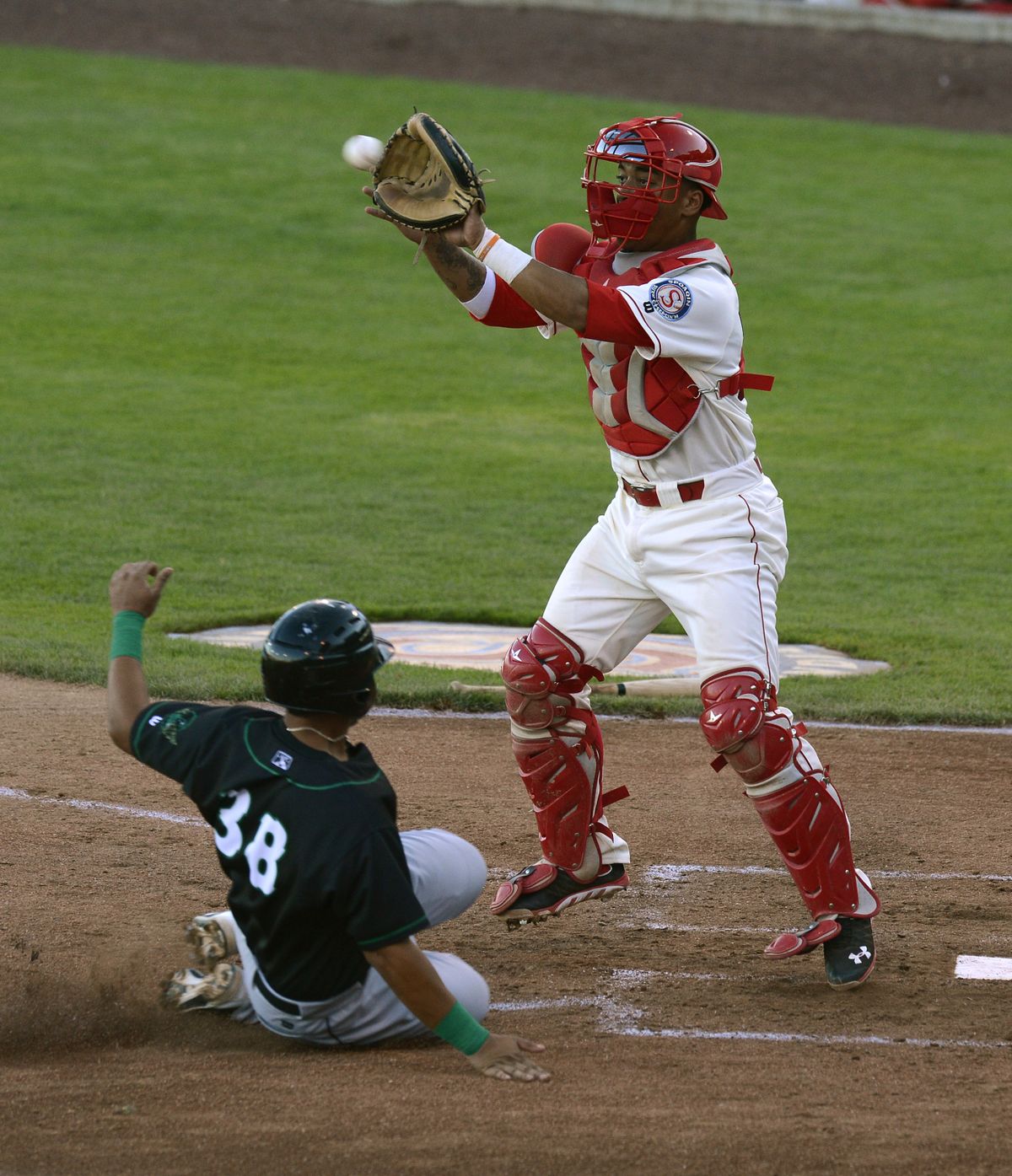 Indians catcher Marcus Greene takes the throw before tagging out Eugene’s Fernando Perez in the fourth inning. (Colin Mulvany)