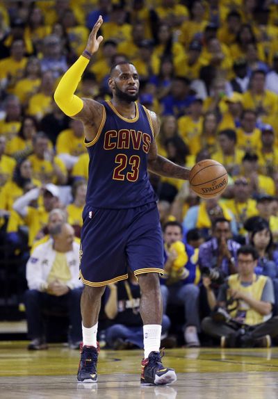 Sources say forward LeBron James will remain with the Cleveland Cavaliers. (Associated Press)