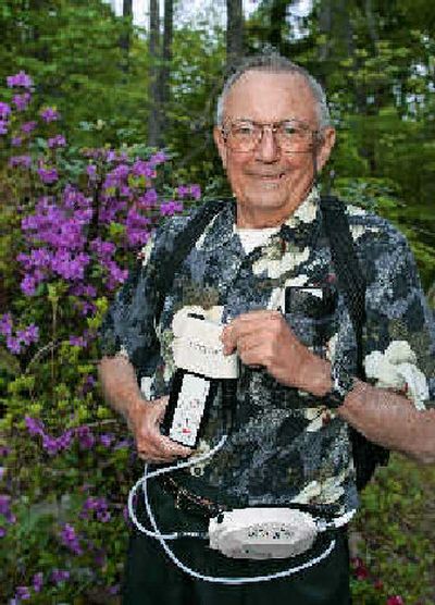 
Robert Graham holds one of the two batteries powering his implanted left-ventricular assist device, or LVAD, at his East Brandywine, Pa., home.  The price of such heart pumps is up to $250,000, with hospital charges. 
 (Associated Press / The Spokesman-Review)