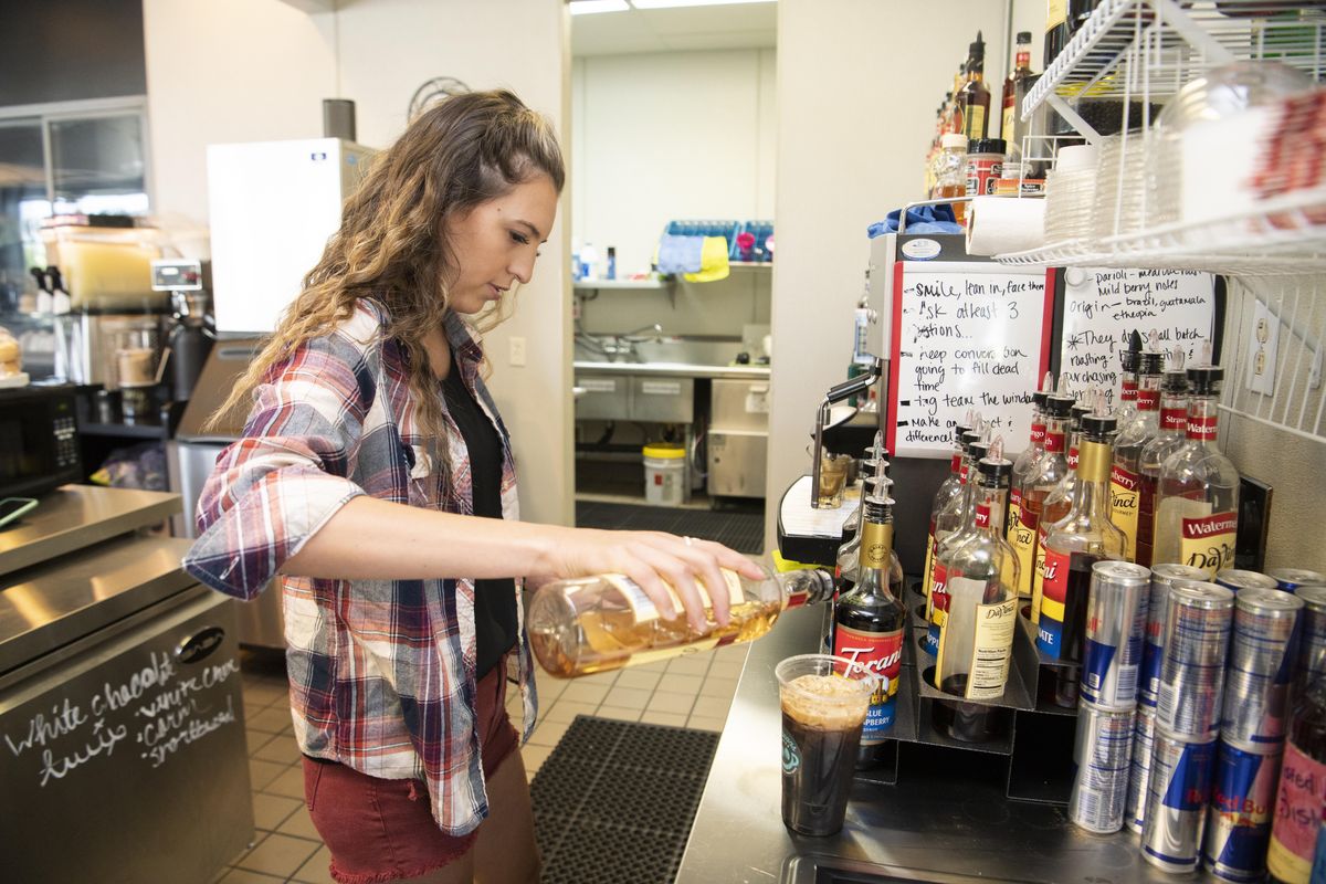 Stephanie Leuker mixes a drink at Cool Beans new valley location, 213 S. University Road in Spokane Valley, Wednesday, Aug. 1, 2018. The drive-thru is open but the walk-in part will open Aug. 18. (Jesse Tinsley / The Spokesman-Review)