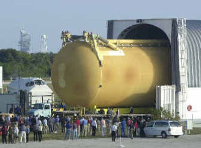 
Discovery's new external fuel tank is transported to the Vehicle Assembly Building at Kennedy Space Center in Cape Canaveral, Fla., in this Jan. 6 photo. The launch pad is in the background. Discovery might return to flight as soon as May 12. 
 (Associated Press / The Spokesman-Review)