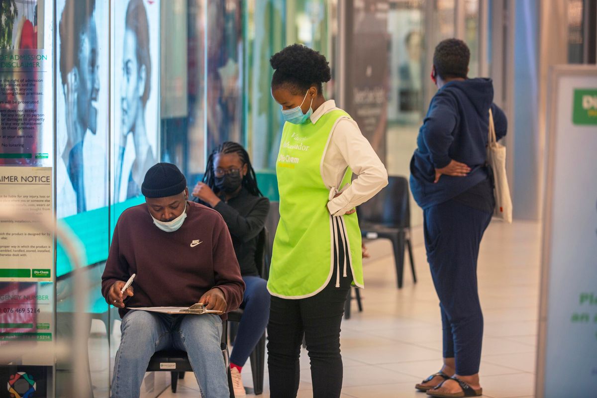 People wait to get vaccinated at a shopping mall in Johannesburg, South Africa, on Friday.  (Denis Farrell)