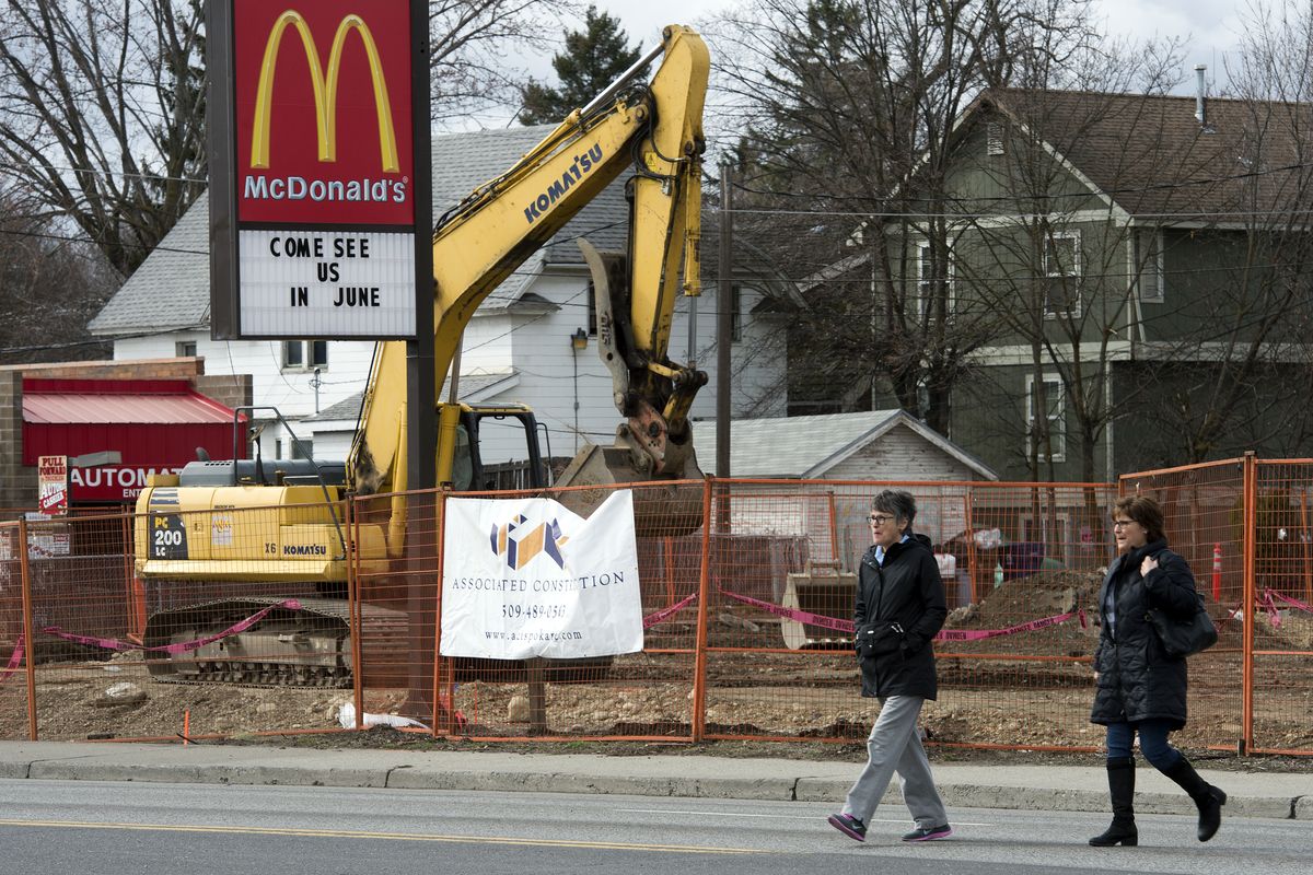 Beth Hyland, left, and her sister Donna Higgins Merkeley cross Hamilton Street at Augusta Avenue on March 28 to attend a press conference concerning the construction of a McDonald’s at that corner. Their family home sits two houses from the construction site on Augusta. (Dan Pelle)