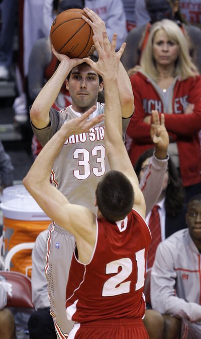 Ohio State's Jon Diebler, top, makes one of his seven 3-point shots. (Associated Press)