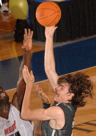 Charlotte's Adam Morrison, right, drives against Torin Francis of Miami. 
 (Associated Press / The Spokesman-Review)