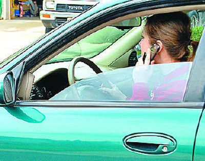 
Washington drivers with cell phones at their ears will be breaking the law next year.  
 (LAUREN COLTON / The Spokesman-Review)