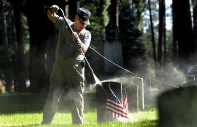 
Vietnam veteran Dusty Rhoads of the Coeur d'Alene chapter of the Vietnam Veterans of America power washed the headstones of veterans from the Civil War, Spanish-American War and WWI on  Sept. 5 at Forest Cemetery in Coeur d'Alene. 
 (Kathy Plonka / The Spokesman-Review)