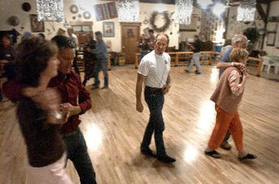 
Bob Crossman walks the two-step class through a lesson at The Crossroads, the nonsmoking, nondrinking dance club in Post Falls. 
 (Jesse Tinsley photos/ / The Spokesman-Review)