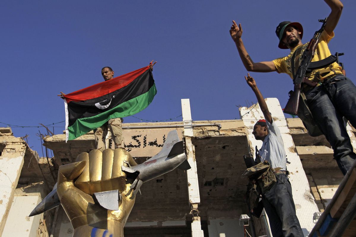 Rebel fighters celebrate inside Moammar Gadhafi