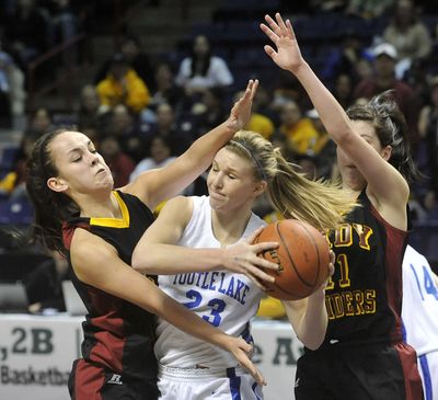 Toutle Lake's Mackenzie Flatz fights through the pressure from Lake Roosevelt's Kaylene Gregory, left, and Hailey Chaney, in the State 2B girls semifinal on Friday at the Spokane Arena. (Dan Pelle / The Spokesman-Review)