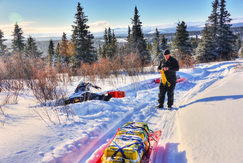 After getting stuck along the Iditarod Trail, Josh Rindal of Spokane rigs up for a tow from Bob Jones.