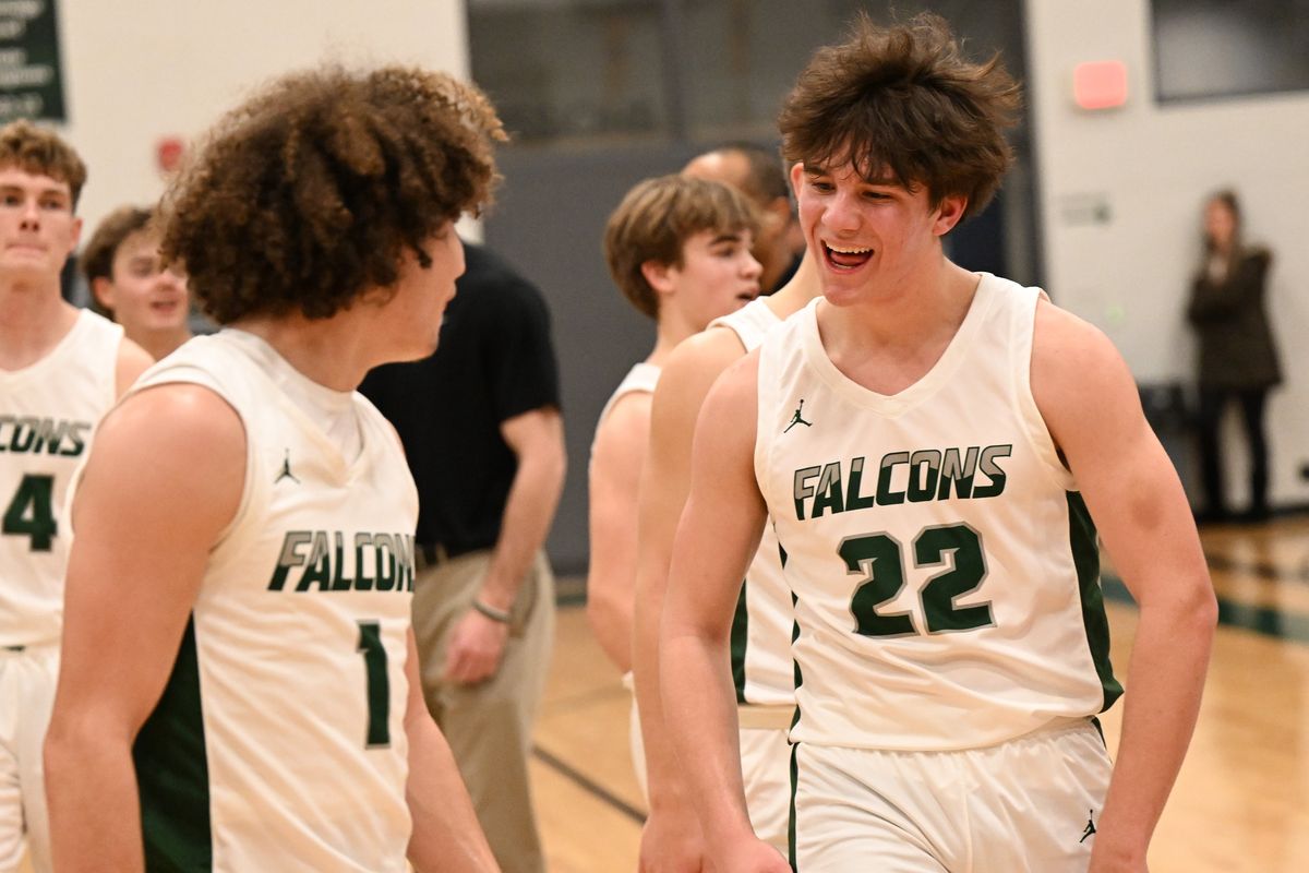 Ridgeline’s Easton Amend (22) smiles with Brayden Allen after the Falcons defeated Cheney during a Greater Spokane League 3A game Tuesday at Ridgeline High School.  (Tyler Tjomsland/The Spokesman-Review)