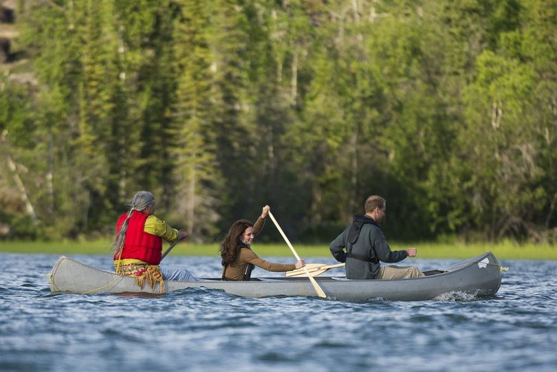 Prince William and wife Kate, the Duke and Duchess of Cambridge take a canoe ride with elder Francois Paulette, left, from the Fort Smith area at Lake Blatchford, Canada, lodge on Tuesday, July 5, 2011.
 (Associated Press)