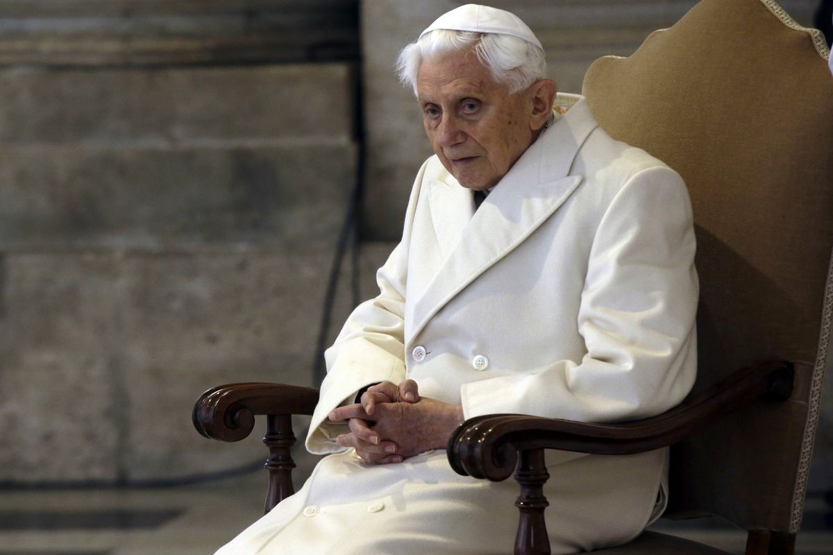 FILE - Pope Emeritus Benedict XVI sits in St. Peter