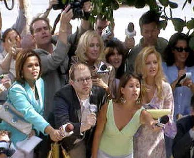 
This image from video, provided by ABC, shows writer Derrik Lang, front second from left, in his role as Paparazzo No. 2 in a crowd of 