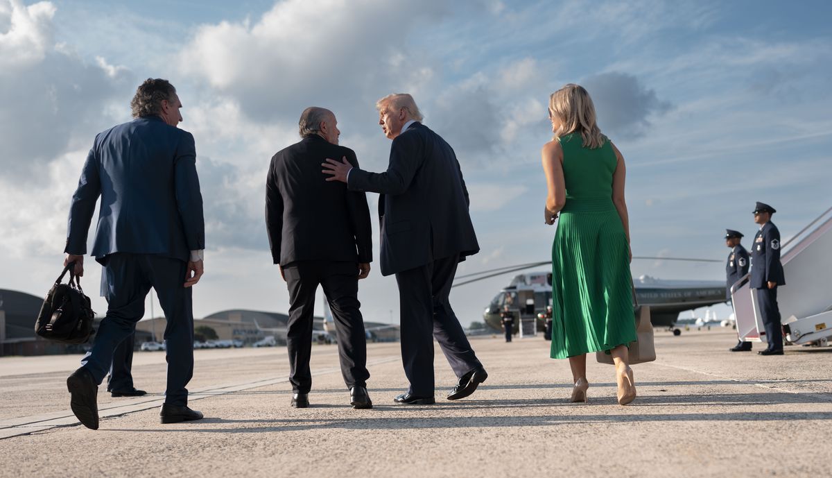 FILE – Commerce Secretary Howard Lutnick, second from left, speaks to President Donald Trump at Joint Base Andrews in Maryland after participating in a summit in Pittsburgh, on July 15, 2025. Lutnick has helped facilitate a series of moves announced by Trump in recent months that expand the economic reach of the government into corporate America. (Doug Mills/The New York Times) (DOUG MILLS)
