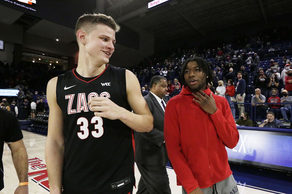 Gonzaga forward Ben Gregg, left, speaks with guard Dominick Harris, who is out with an injury, after the Zags’ Nov. 15 home game.  (Associated Press)