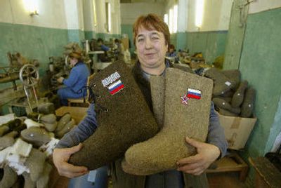 Seamstress Valentina Kokoreva shows off the latest fashion in felt books in Kalyazin, Russia . For generations, this Volga River town has been known for its valenki, the felt boots that protect the feet of Russian children and adults from the harsh winter. 
 (Associated Press / The Spokesman-Review)